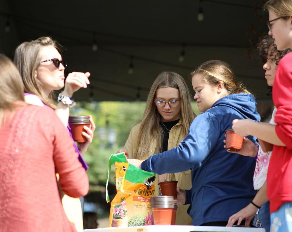 Students talk an prepare plants as part of a campus activity